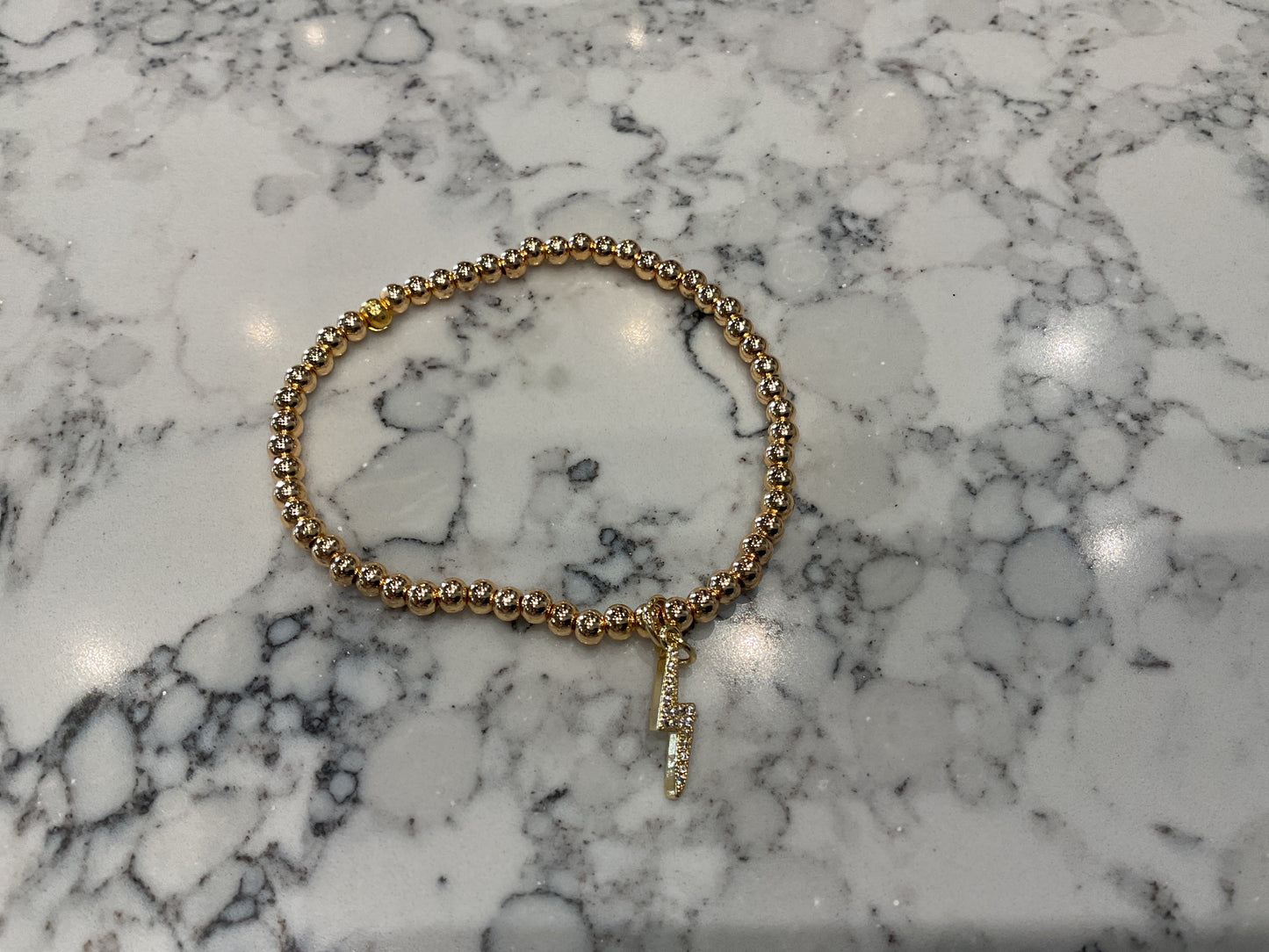 Lightning charm bracelet gold